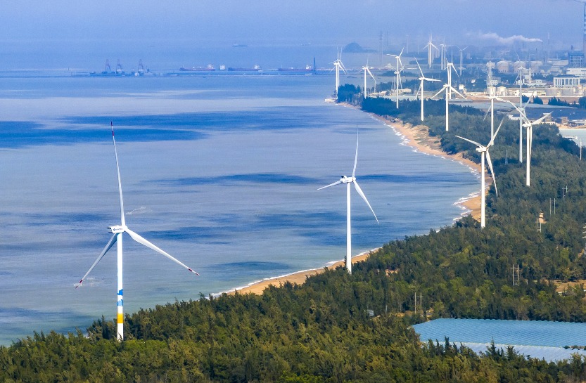 Wind turbines Wind turbines stand along the coastline of Hainan