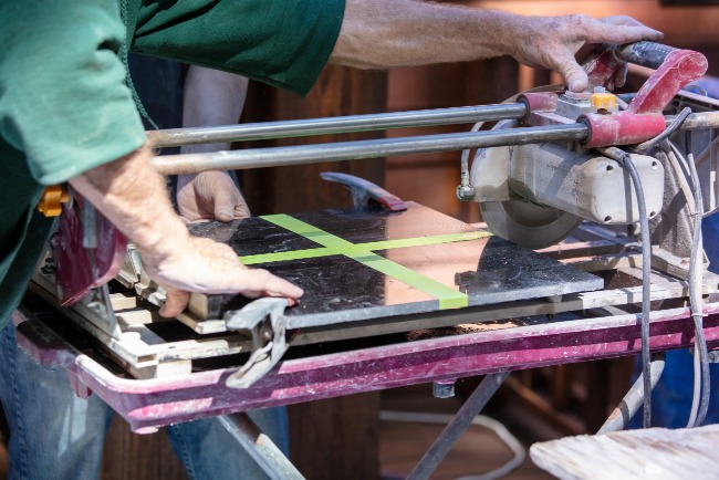 Materials containing diamonds are often used for industrial cutting and polishing. The picture shows a worker cutting granite with a diamond saw.