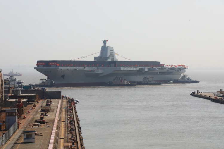 Pictured is the Fujian aircraft carrier slowly leaving the dry dock after its launching and naming ceremony.