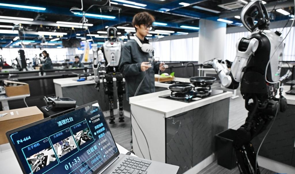 At the Qingdao City humanoid robot data collection training ground, a trainer guides a robot's training in a home organisation scene.