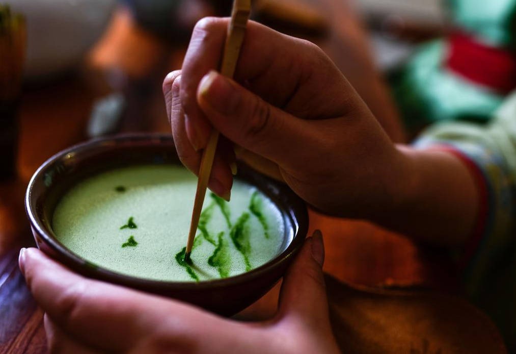 The image above shows tea farmers picking tea in Nishio City, Japan; the image below shows a matcha processing plant in Uji City.0
