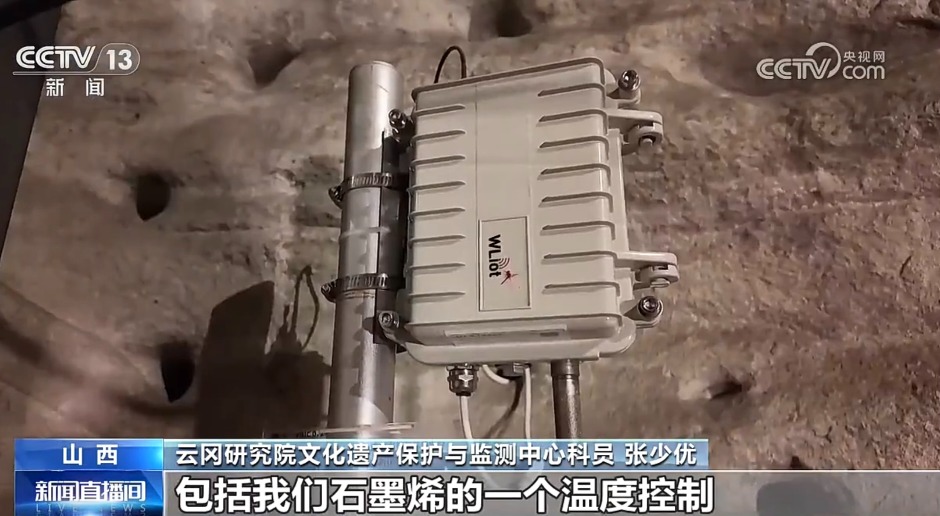 雲岡石窟內的石墨烯溫控相關設備，灰色箱體固定於岩壁前的金屬支架，底部連接線纜。
